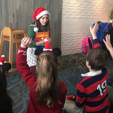 Magician engaging children in magic show during Christmas time